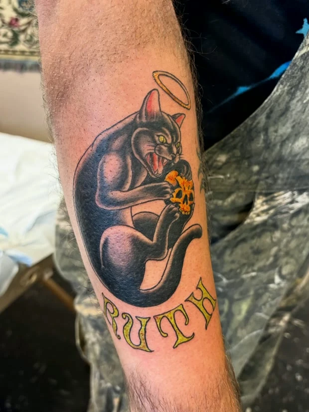 Traditional panther with lettering, tattooed by Cara