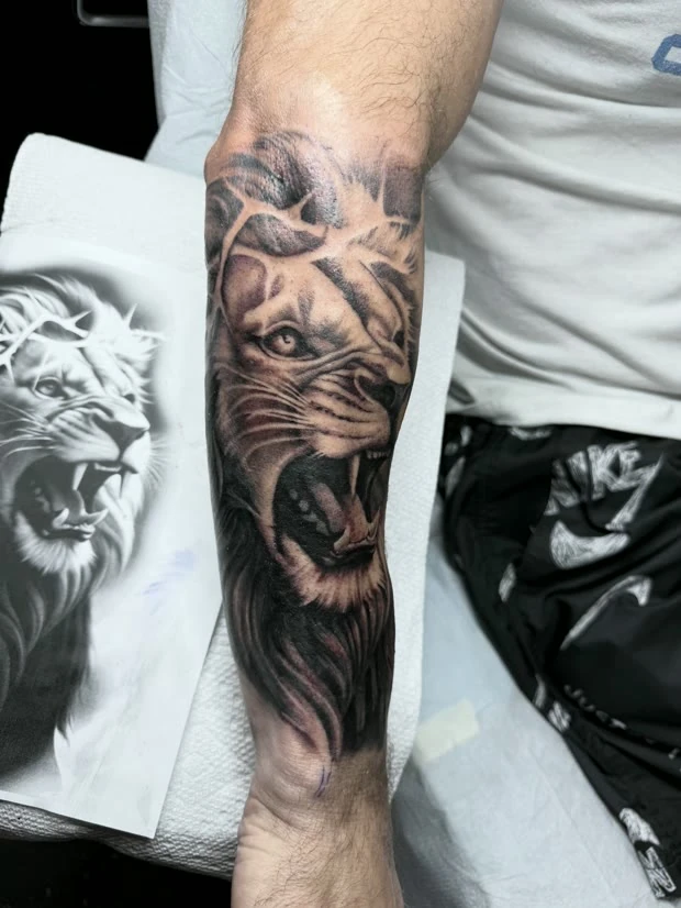 Black and grey lion sleeve, tattooed by Tevin