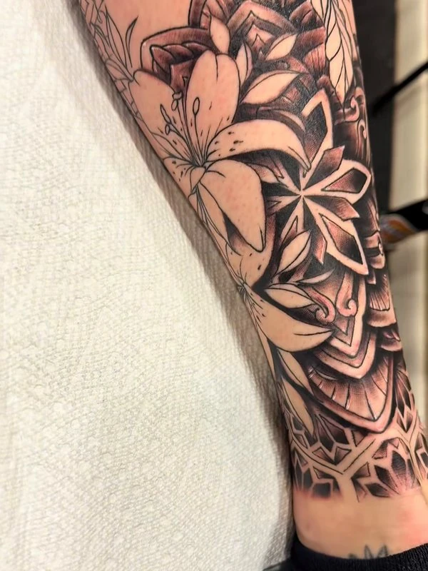 Mandala florals on a calf, tattooed by Jordan