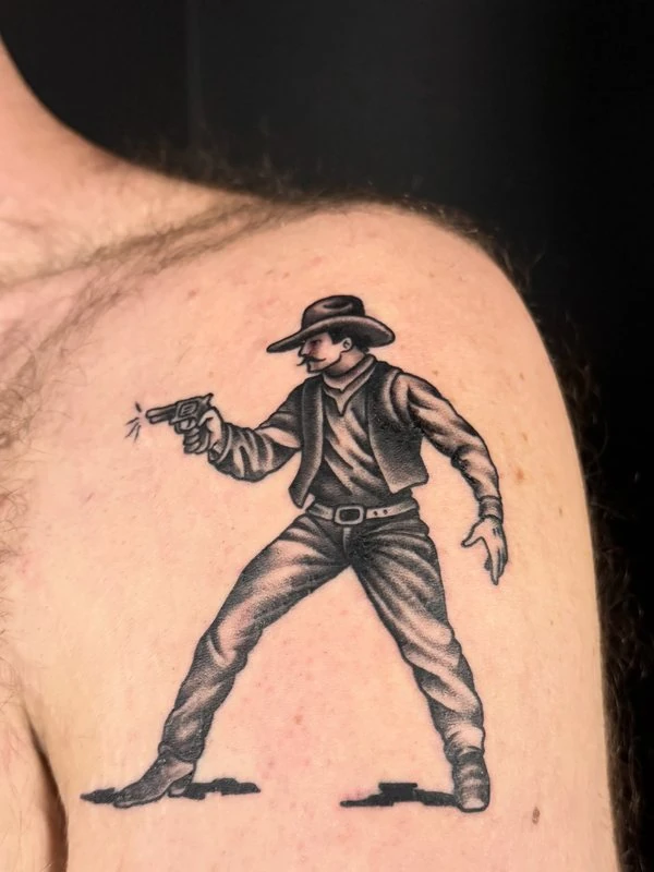 Gunslinger in black and grey, tattooed by Tevin