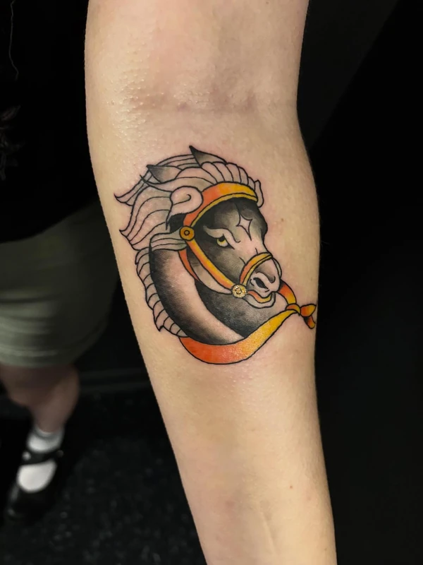Horse head with a ribbon, tattooed by Cara