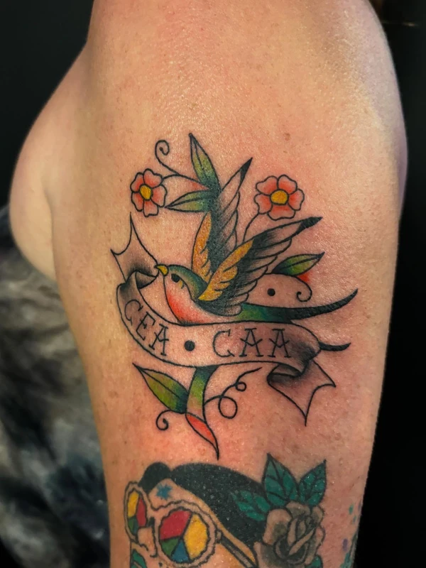 Swallows with a banner, tattooed by Cara