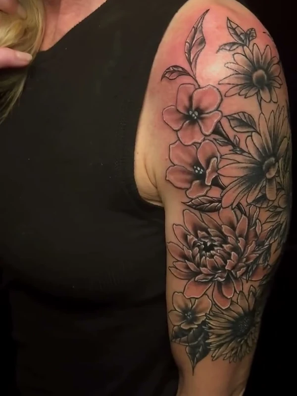 Floral half sleeve, tattooed by Jordan