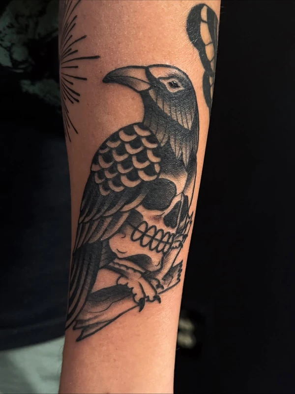 Raven over a skull, tattooed by Tevin